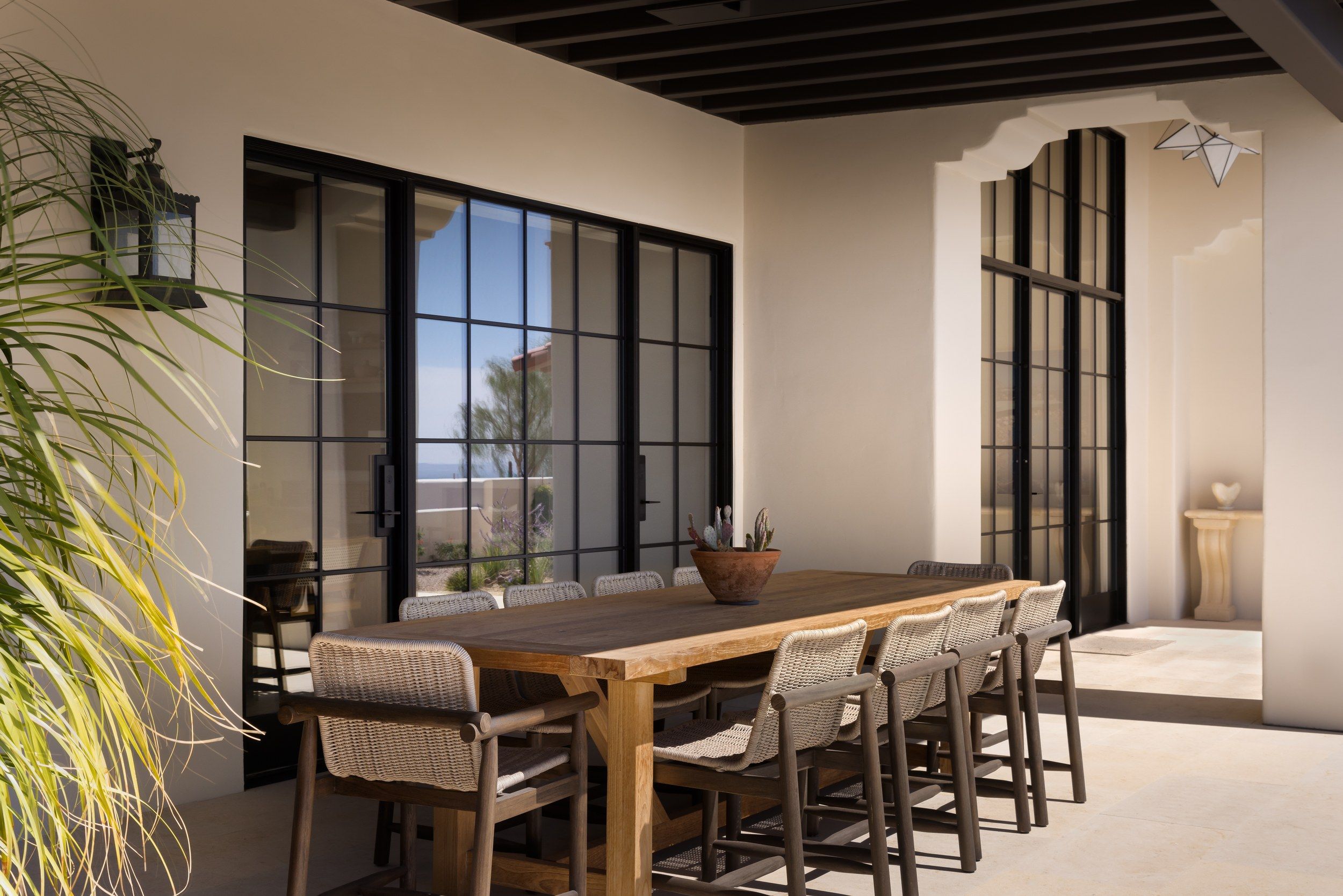 Dining room with steel windows and a live-edge table